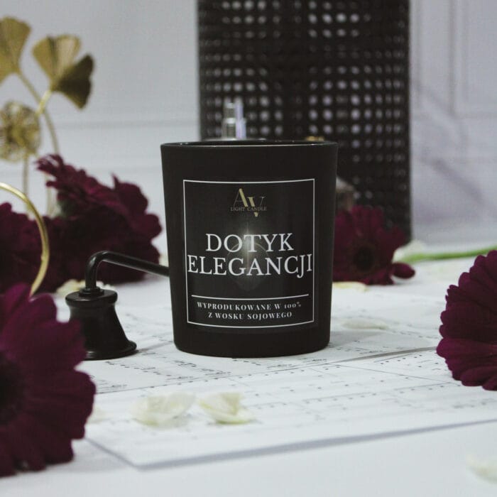 Świeca Dotyk Elegancji Lumor z akcentami biżuterii i flakonami perfum w tle